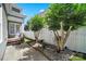 Inviting side yard featuring lush greenery and a charming white picket fence at 1855 Second Baxter Xing, Fort Mill, SC 29708
