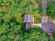Aerial view of property featuring the home, garage, driveway, landscaping, and wooded surroundings at 1904 Lark Ln, Stanley, NC 28164