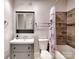 This bathroom features a shower with beautiful tile, a sink with storage, and a toilet at 1904 Lark Ln, Stanley, NC 28164