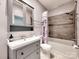 Bathroom featuring a vanity with storage, a shower-tub combo with stylish tile surround, and neutral tones at 1904 Lark Ln, Stanley, NC 28164