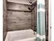 The updated bathroom boasts stylish tile, a showerhead, and a soaking tub at 1904 Lark Ln, Stanley, NC 28164