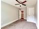 Neutral bedroom offers soft carpet, ceiling fan, and a view of the staircase at 1904 Lark Ln, Stanley, NC 28164