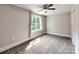 Bright bedroom features soft carpet, neutral walls, ceiling fan, and a large window with curtains at 1904 Lark Ln, Stanley, NC 28164