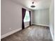 Neutral bedroom with carpeting, a ceiling fan, and a window with curtains at 1904 Lark Ln, Stanley, NC 28164