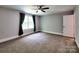 Spacious bedroom featuring carpet flooring, a ceiling fan, and windows for natural light at 1904 Lark Ln, Stanley, NC 28164