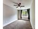 Carpeted bedroom with window, fan, and neutral color palette at 1904 Lark Ln, Stanley, NC 28164