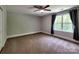 Neutral bedroom with carpeting, a ceiling fan, and a window providing natural light at 1904 Lark Ln, Stanley, NC 28164