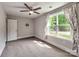 Bedroom with ceiling fan, soft carpet, and a large window overlooking the greenery at 1904 Lark Ln, Stanley, NC 28164