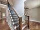 Elegant foyer with a staircase featuring wrought iron spindles and wood treads, leading to hardwood floors at 1904 Lark Ln, Stanley, NC 28164