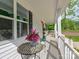 Inviting front porch with decorative plants, a table and chairs providing a relaxing outdoor space at 1904 Lark Ln, Stanley, NC 28164