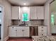 Well-lit kitchen features white cabinets, stainless steel appliances, granite counters, and a subway tile backsplash at 1904 Lark Ln, Stanley, NC 28164