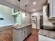 Modern kitchen boasts granite counters, an island with pendant lights, and stainless steel appliances at 1904 Lark Ln, Stanley, NC 28164