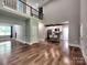Open-concept living room with hardwood floors, a kitchen island, and a beautiful wrought iron staircase at 1904 Lark Ln, Stanley, NC 28164