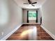 Inviting living room with hardwood floors, a ceiling fan, and a large window overlooking the trees at 1904 Lark Ln, Stanley, NC 28164
