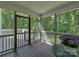 Relax on this screened-in porch overlooking a lush backyard and landscaping at 1904 Lark Ln, Stanley, NC 28164