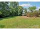 Large grassy backyard with mature trees at 205 Dogwood Ln, Dallas, NC 28034