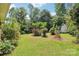 Lush backyard featuring mature trees and grass, offering a private and serene outdoor space at 205 Dogwood Ln, Dallas, NC 28034