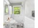 Bathroom featuring a classic pedestal sink, tiled walls, and a window for natural light at 205 Dogwood Ln, Dallas, NC 28034