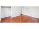 Bedroom with hardwood floors, closet, and neutral walls creating a serene atmosphere at 205 Dogwood Ln, Dallas, NC 28034