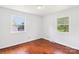 Well-lit bedroom with hardwood floors and large windows offering outside views at 205 Dogwood Ln, Dallas, NC 28034