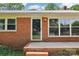 Charming brick home featuring a glass front door and well-maintained front porch at 205 Dogwood Ln, Dallas, NC 28034
