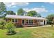 Charming brick home with well-maintained lawn, mature trees, and front walkway at 205 Dogwood Ln, Dallas, NC 28034