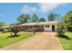Quaint brick home with lush landscaping and paved driveway at 205 Dogwood Ln, Dallas, NC 28034