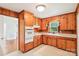 Cozy kitchen with knotty pine cabinets, and white appliances at 205 Dogwood Ln, Dallas, NC 28034