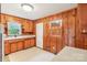Kitchen features knotty pine cabinets, sink, and window at 205 Dogwood Ln, Dallas, NC 28034