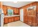Kitchen features knotty pine cabinets, sink, and window at 205 Dogwood Ln, Dallas, NC 28034