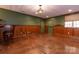 Spacious finished basement with wood paneling and unique stained concrete flooring at 2101 Congress Ct, Kannapolis, NC 28083