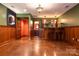 Finished basement with a wet bar, wainscoting, and stained concrete floors at 2101 Congress Ct, Kannapolis, NC 28083