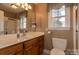 Bathroom featuring a single sink vanity, toilet, and shower-tub combination at 2101 Congress Ct, Kannapolis, NC 28083