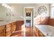 Well-lit bathroom with jacuzzi tub, tile surround, vanity, and a large mirror at 2101 Congress Ct, Kannapolis, NC 28083