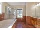 Luxurious bathroom featuring a jacuzzi tub, tiled walls, and a glass shower at 2101 Congress Ct, Kannapolis, NC 28083