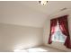 Well-lit bedroom with plush carpet and a large window draped with curtains at 2101 Congress Ct, Kannapolis, NC 28083