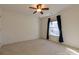 Comfortable bedroom with plush carpet and a large window draped with curtains at 2101 Congress Ct, Kannapolis, NC 28083