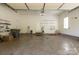 Spacious garage with tools, shelving, and ample storage space with a door to the interior at 2101 Congress Ct, Kannapolis, NC 28083