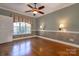 Well-lit living room featuring hardwood floors, white trim, and a ceiling fan at 2101 Congress Ct, Kannapolis, NC 28083