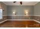View of large living room with hardwood floors, and dual sconce lighting at 2101 Congress Ct, Kannapolis, NC 28083
