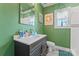 This bathroom features green walls, a stylish vanity, and a window providing natural light at 222 N Weldon St, Gastonia, NC 28052