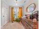 Well-lit bedroom featuring a vintage dresser, classic mirror, and bright windows at 222 N Weldon St, Gastonia, NC 28052