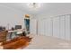 A spacious bedroom offers carpeted floors, large closets and unique light fixture at 222 N Weldon St, Gastonia, NC 28052