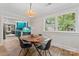 Dining room with a modern light fixture, dining table, and view to the kitchen at 222 N Weldon St, Gastonia, NC 28052