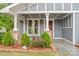 Covered front porch enhanced with elegant columns and colorful landscaping at 222 N Weldon St, Gastonia, NC 28052