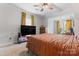 A spacious main bedroom features a ceiling fan, windows with bright light and cozy carpet at 222 N Weldon St, Gastonia, NC 28052