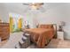 Spacious main bedroom with ceiling fan, carpet, and bright windows at 222 N Weldon St, Gastonia, NC 28052