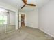 Bedroom with carpet, ceiling fan, closet, and access to other rooms in the house at 233 Northwest Dr, Davidson, NC 28036