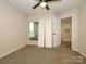 Bedroom with neutral carpet, bright window, and access to other rooms in the house at 233 Northwest Dr, Davidson, NC 28036