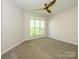 Bedroom with neutral carpet, bright window, and ceiling fan at 233 Northwest Dr, Davidson, NC 28036
